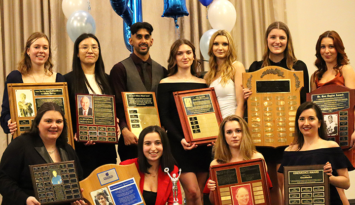 Athletic Therapy Students showing off their awards at the Mississauga Grand banquet hall on March 31st 2023. Top row from left to right: Jessica Sluys, Meggie Lesage, Christopher Singh, Taylor Beausoleil, Maxine DeCiantis, Callista Tsangarakis and Ariel Barook. Bottom row from left to right: Jamie Van Goozen, Rosalina Lombardi, Bridget Chiasson and Samantha Raymond.